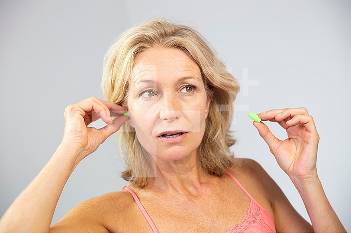 Woman using earplugs.