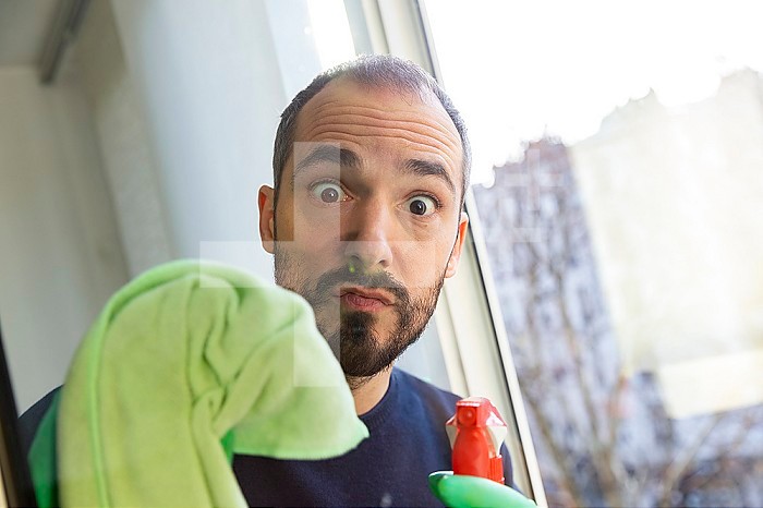 A man cleaning a window.