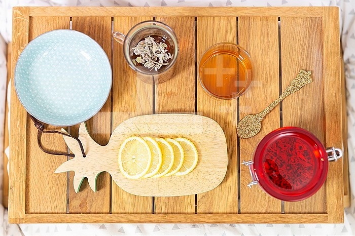 Tray with a slice of lemon, herbal tea and honey.