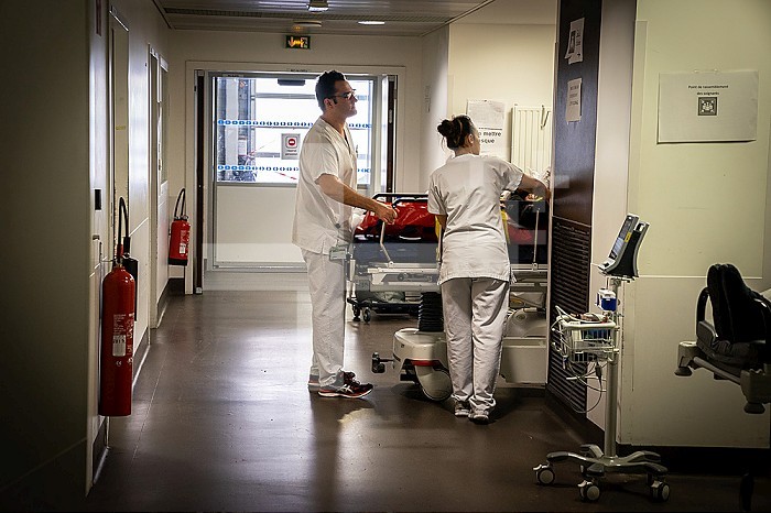 Nurses take care of a patient placed in a stretcher.