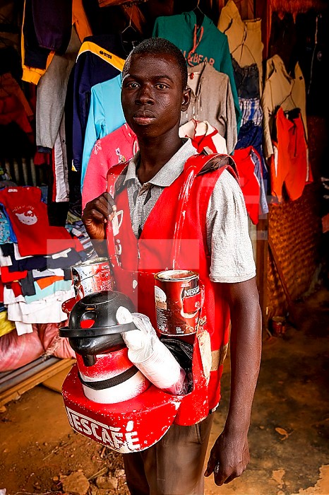 Young man selling instant coffee in Ouagadougou, Burkina Faso.