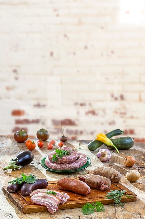 Raw sausage with parsley leaf isolated on white background.