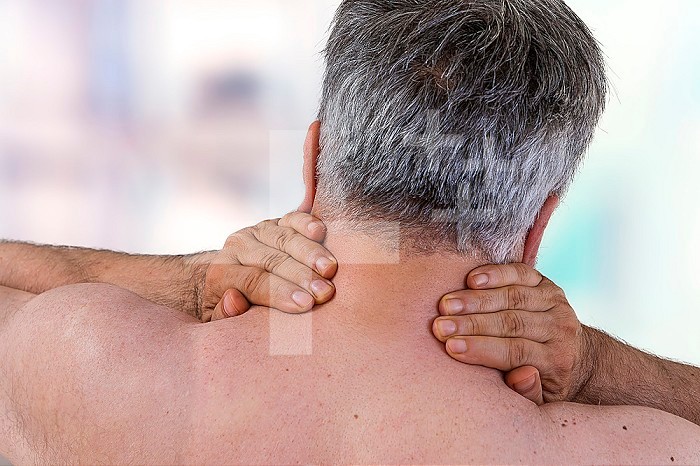 Neck Pain.Medical concept. Senior man touches neck, pain in the neck, rear view