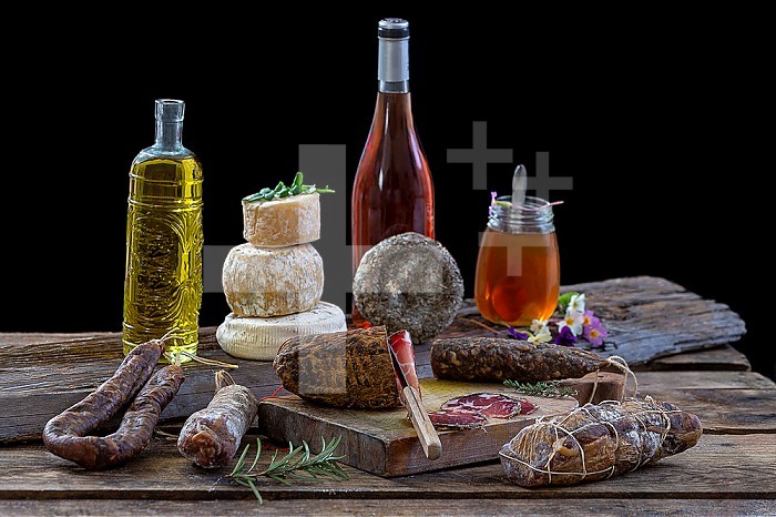 Several variety of traditional Corsican delicatessen on rustic background.