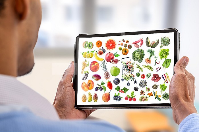 Healthy nutrition concept on a tablet.young man holding digital tablet with healthy