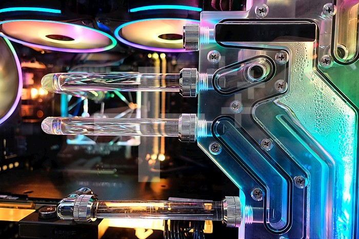 Gaming computer with liquid cooling, water, and computer fan light.