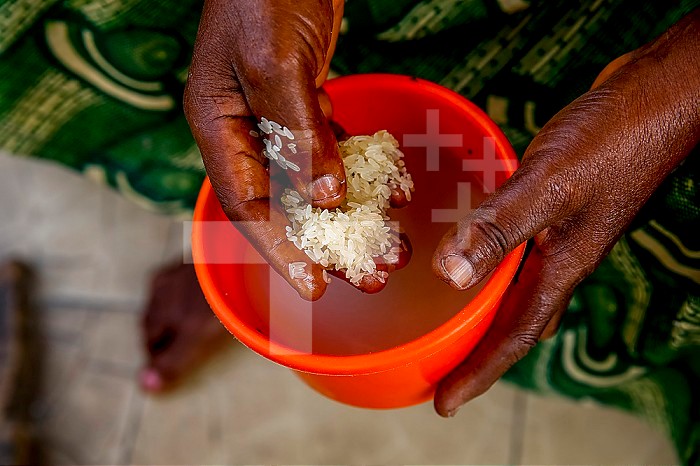 Oasis of Love, a catholic center for mentally disabled persons in Kpalime, Togo. Disabled person´s mother eating rice.
