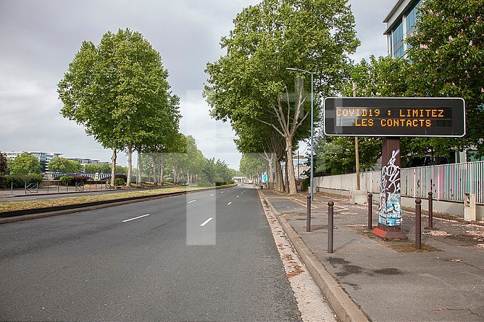 Light panels inviting to limit contacts during the health crisis related to coronavirus, at the edge of the empty road on the quay of Seine in Asniere-sur-Seine, France, Europe.