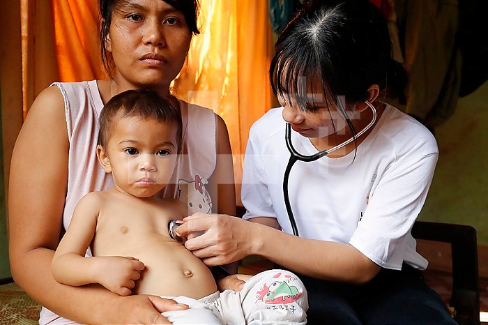 Volunteer of French NGO Chaine de l´Espoir visiting a child suffering of heart disease. Medical consultation. Buon Me Thuot. Vietnam.