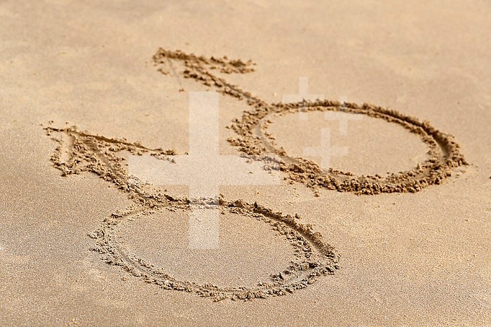 Male gender symbols written on sand beach. Gay symbol.