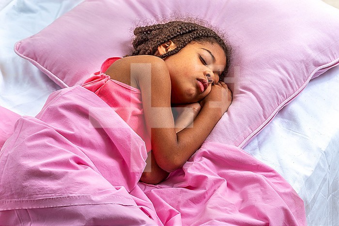 Sleeping beauty. Beautiful girl lying with t in her hand. Close-up portrait of sleeping 10 years girl. Cute . Child portrait in pastel tones. succking thumb Top view.