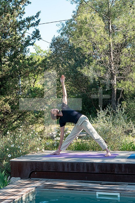 Man practicing Yoga outdoors.