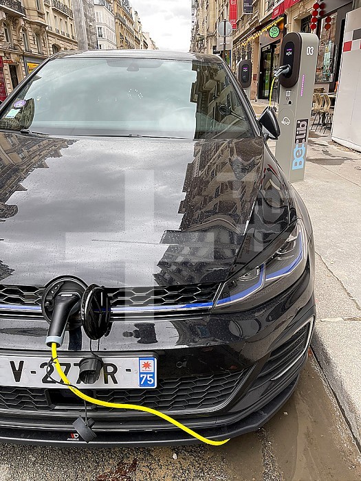 Electric car being charged at a terminal in the city of Paris, France.