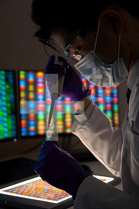 Male researcher in front of genome screens.