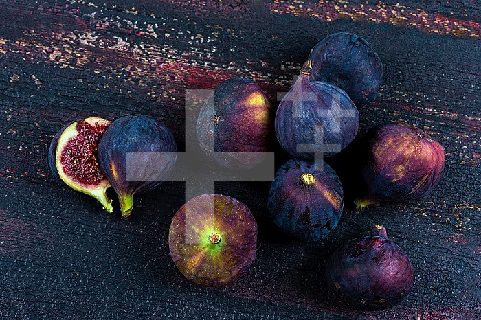 Harvest of black figs rich in minerals and trace elements on an old board.