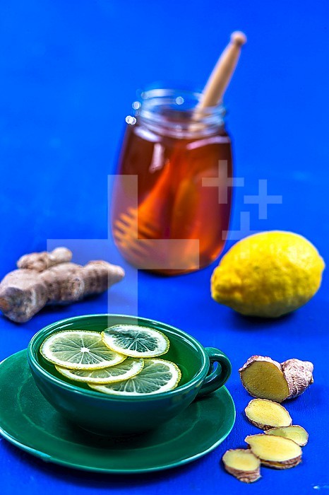 Herbal tea with ginger, lemon and honey in a cup.