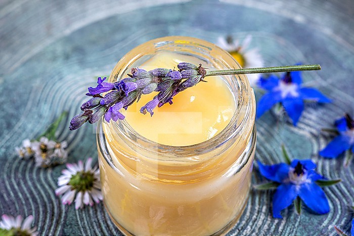 Jar of royal jelly and sprig of lavender.