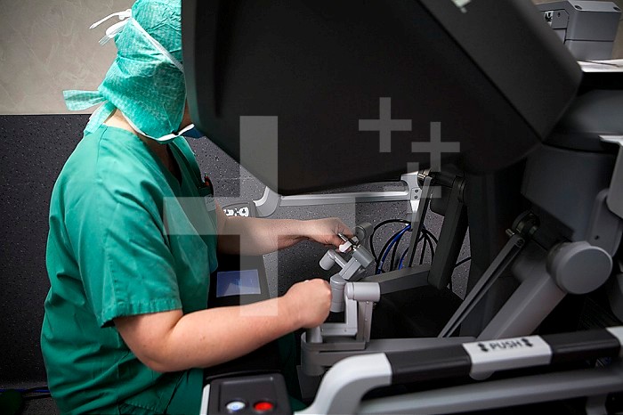 Hysterectomy in the operating room with a robot controlled by a surgeon from a console.