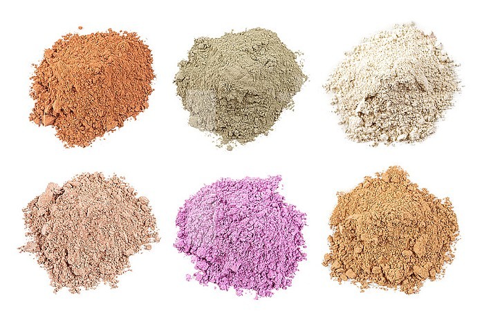 Assortment of clay powders on white background.