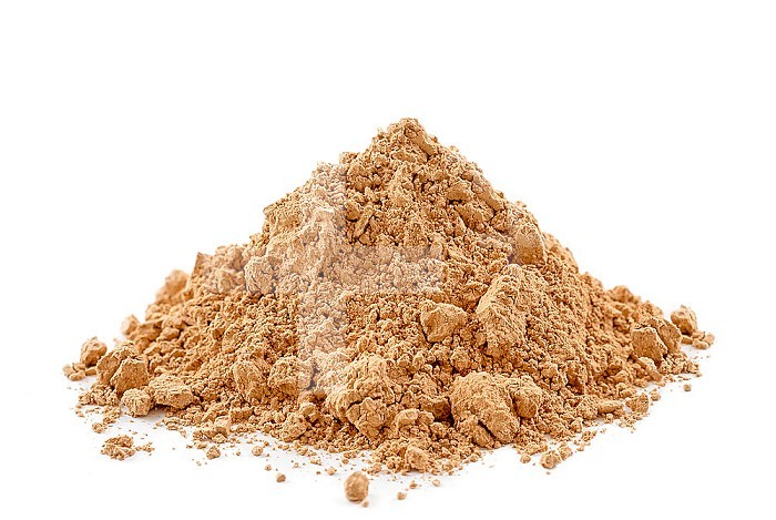 Heap of ultra ventilated yellow clay on white background.