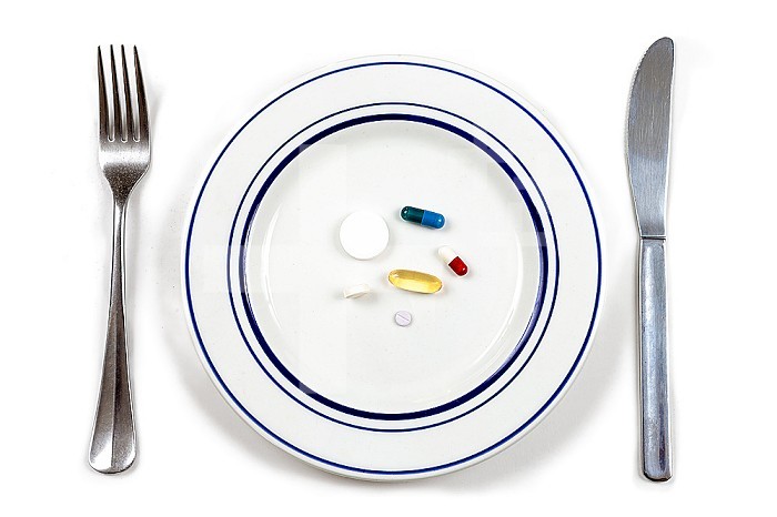 Medicines in a plate on a white background.