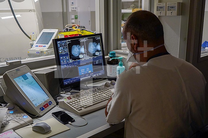Doctor observing the images of a scanner in the emergency room of a university hospital.