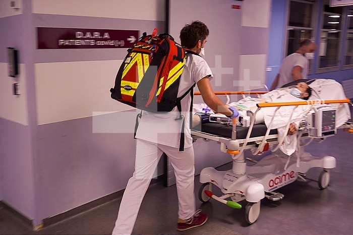 Doctor transporting a patient to the emergency imaging department of a university hospital.