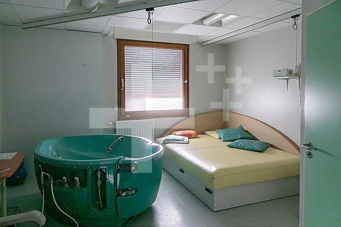 Delivery room with birth bath or dilation bath where the hot water bath can facilitate the dilation of the cervix.