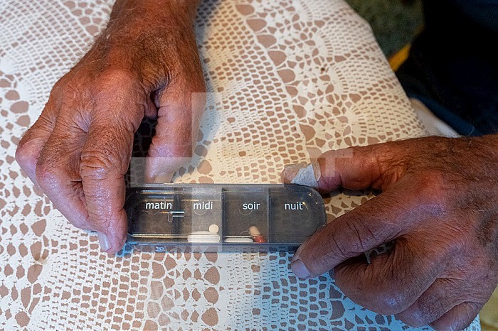Pillbox of a 90-year-old senior on the tablecloth.