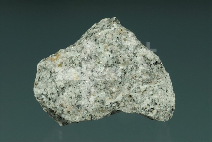 Granite is a crystalline igneous rock consisting of potassium feldspar and quartz with hornblende and mica as common accessory minerals.