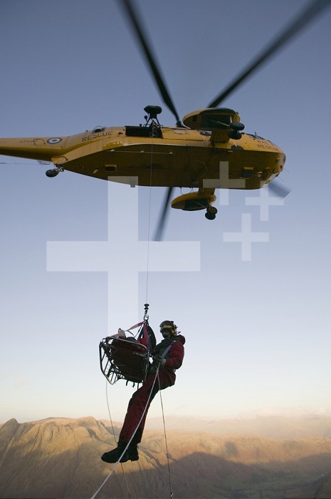 An RAF Sea King helicopter aiding in the rescue of an injured person in the Lake District, United Kingdom.