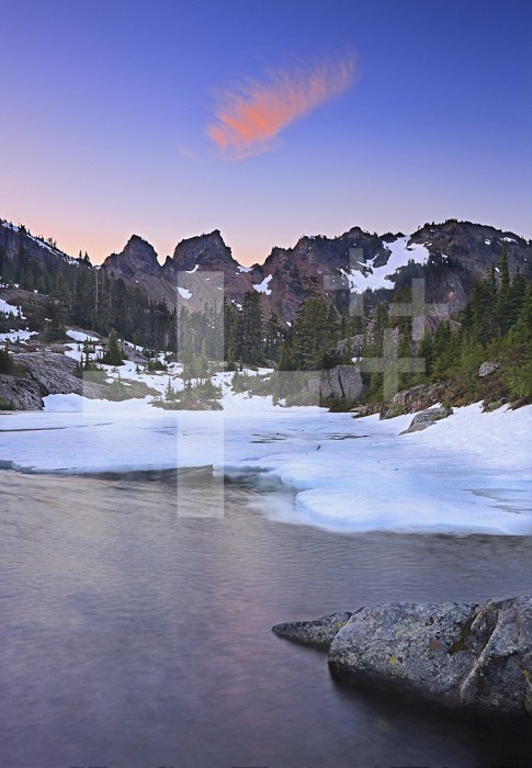 Lila Lake in the Alpine Lakes Wilderness of the Cascade Range with slowly melting snow in early July, Washington, USA.