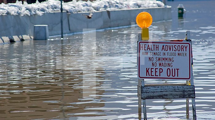 A sign warns of raw sewage in floodwater during the historic 2008 flood on the Mississippi River in Burlington, Iowa.