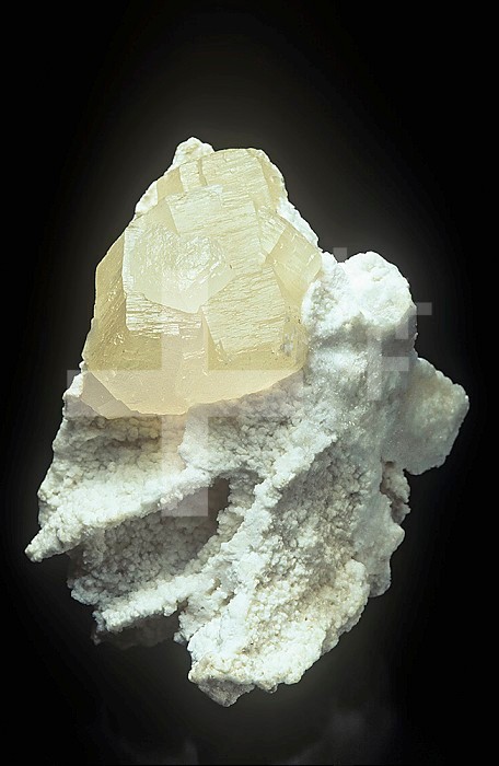 Witherite crystal on Barite, a fluorescent mineral photographed under normal white light, Illinois, USA.