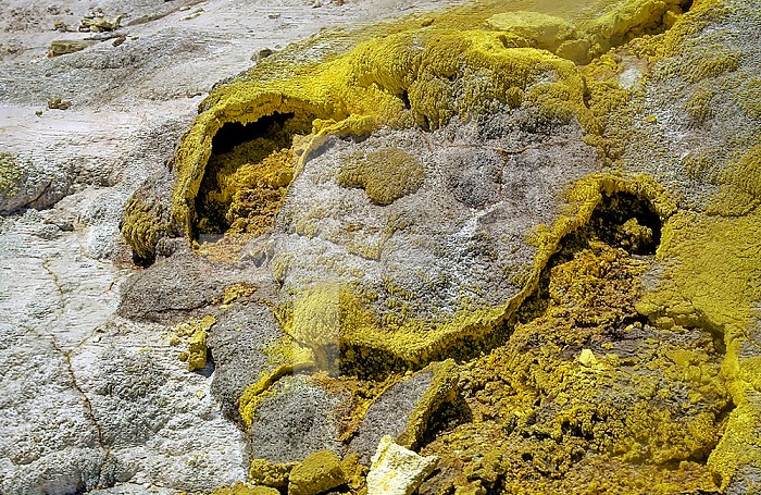 Steam and sulfur condensed at the mouth of a fumarole vent. Rotorua, New Zealand.