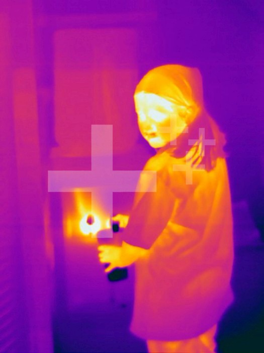 Thermogram - Child getting cup of cold water from cooler - The colors show temperature variation. The temperature scale runs from white (warmest) through yellow, orange, red, purple and black (coldest)
