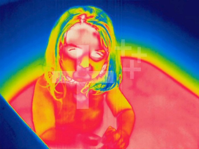 Thermogram - Child in tub - The colors show temperature variation.  The temperature scale runs from white ,warmest, through red, yellow, green and cyan, blue and black ,coldest,