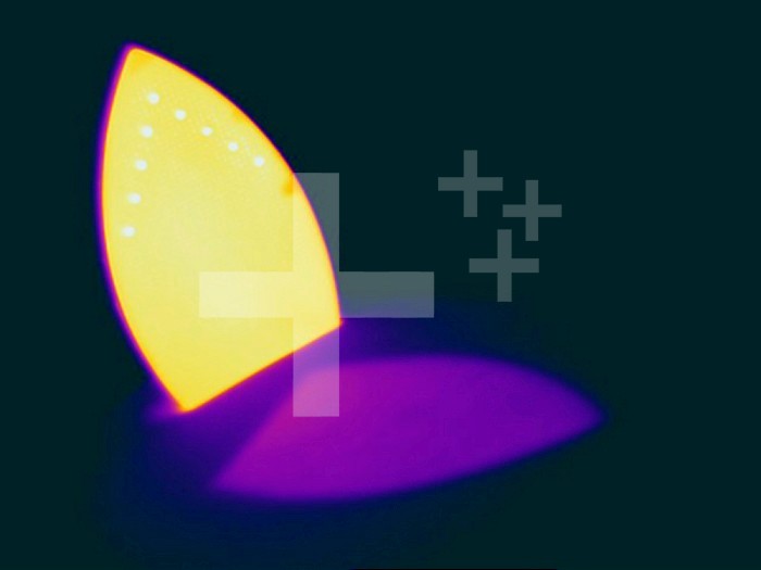 Thermogram of a hot iron. The colors show temperature variation with the temperature scale running from white (warmest) through yellow, orange, red, purple and black (coldest).