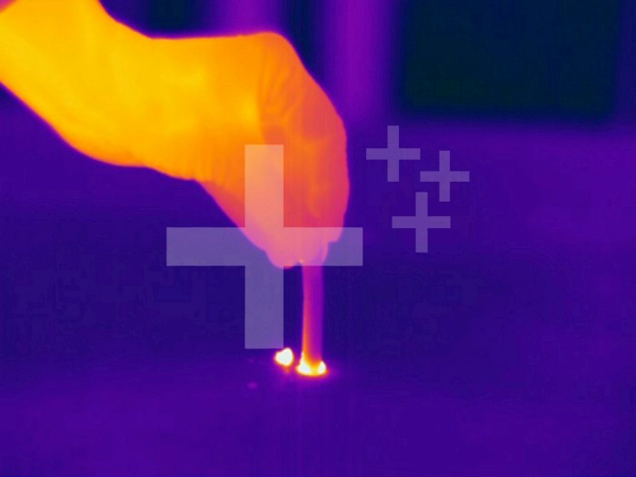 Thermogram - Extinguishing lit cigarette - The colors show temperature variation. The temperature scale runs from white (warmest) through yellow, orange, red, purple and black (coldest)