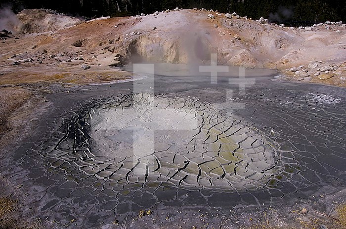 Dried hot spring with the mineral kaolinite and cracks found in the Bumpass Hell area of Lassen National Park, California, USA.