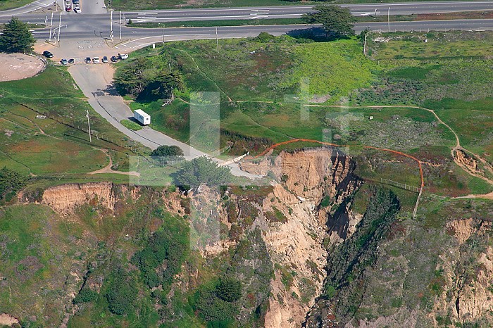 Road destroyed by sea cliff retreat, California, USA.