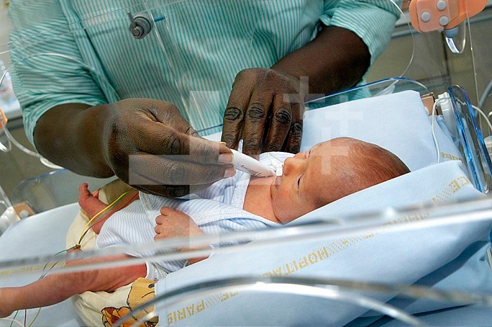 Reportage in the neonatal unit of Robert-Debre hospital in Paris, France. Taking the baby´s temperature.