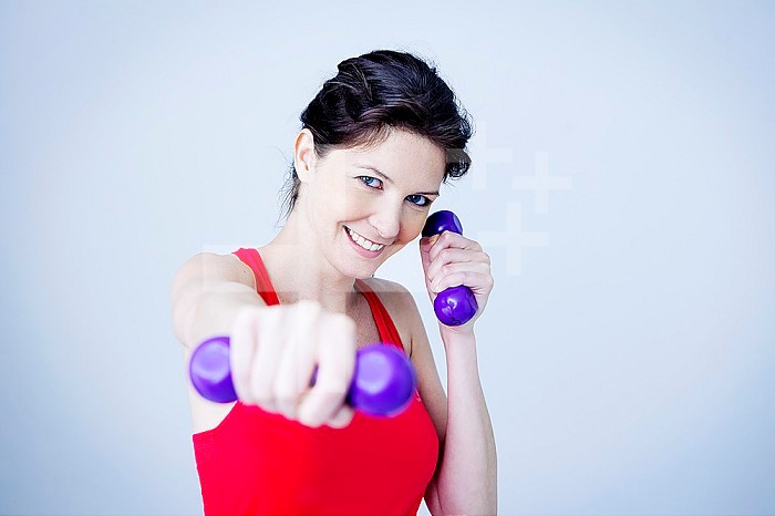 Woman using hand weights.