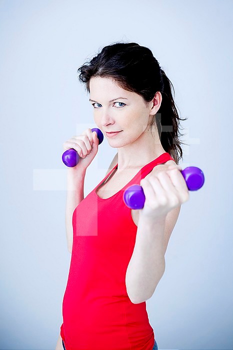 Woman using hand weights.