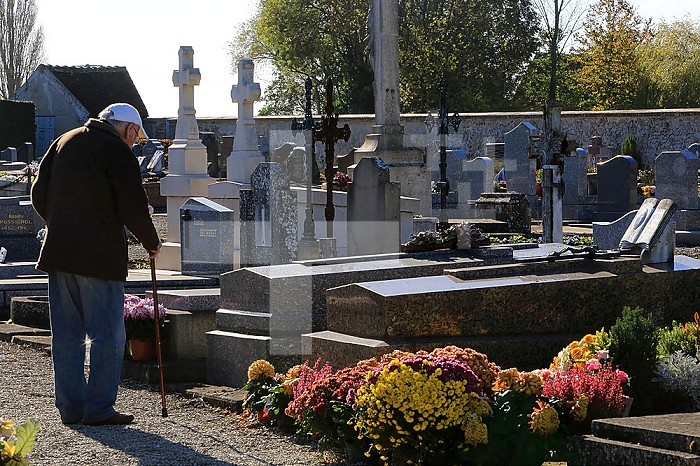 Retired praying at his wife´s grave.