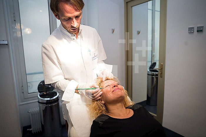 Reportage in the Mozart Clinic in Nice, France. Injecting botulinum toxin. Botulinum toxin is used to provoke muscle paralysis in order to reduce wrinkles.