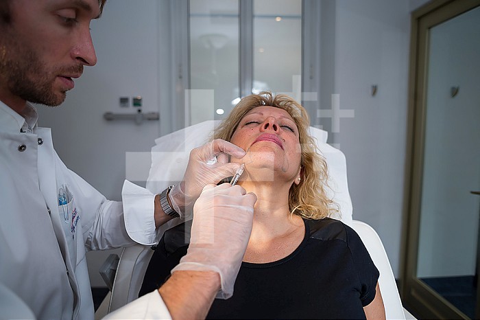 Reportage in the Mozart Clinic in Nice, France. Injecting hyaluronic acid in the facial contour. Hyaluronic acid is a gel that fills in wrinkles.