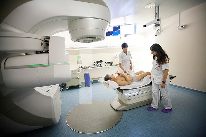 Reportage in a radiation oncology service in Switzerland. The service is equipped with the latest linear accelerator, the Truebeam. Technicians set a patient up for prostate cancer treatment.