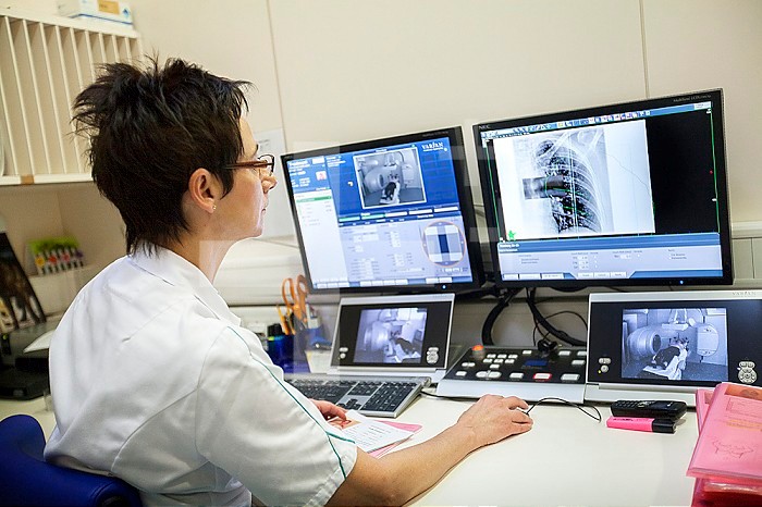 Reportage in a radiation oncology service in Switzerland. The service is equipped with the latest linear accelerator, the Truebeam. A technician controls the treatment session.