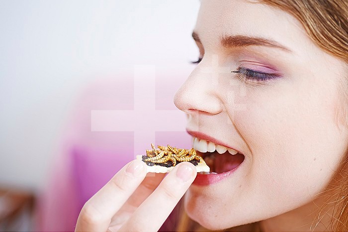 Woman eating mealworms.